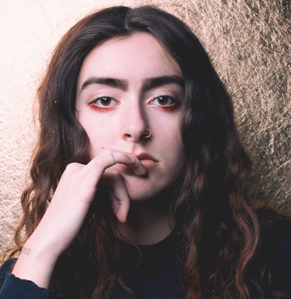 headshot of a person with a nose ring