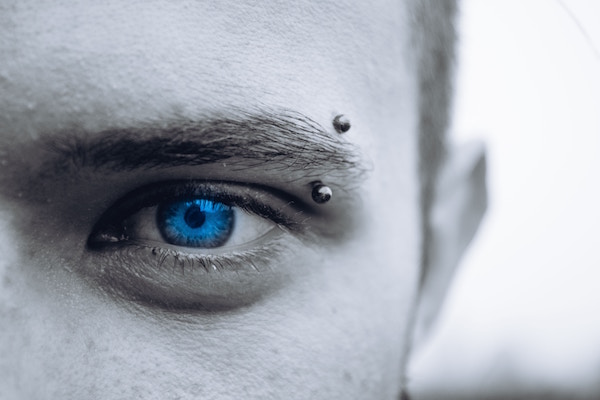 Man with eyebrow piercing and curved barbell jewelry